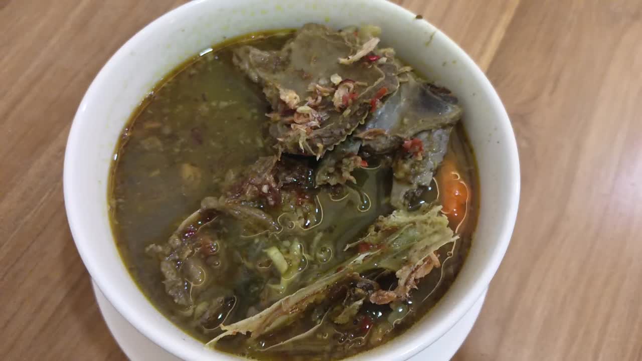 Tengkleng, Indonesian Traditional Food made from Lamb Bone isolated on wooden table background.