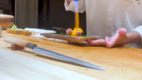 sushi preparation with torching technique in bangkok