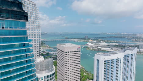 Fly-around-skyscraper-under-construction.-Revealing-panoramic-view-of-coast,-islands-and-sea-cruise-terminal.-Miami,-USA
