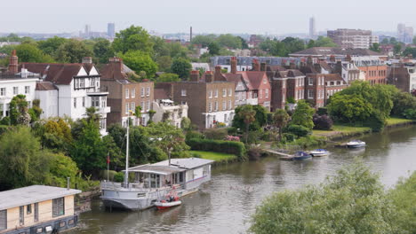 houses and boats along the river thames