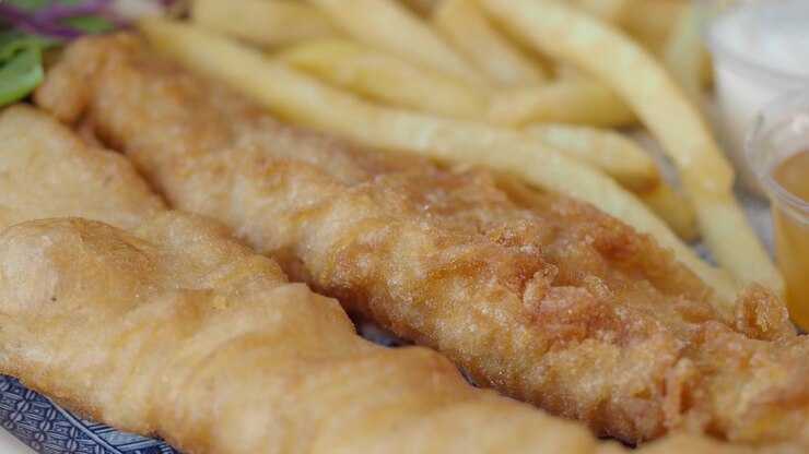 Close-up of Crispy Battered Fish and French Fries on a Plate