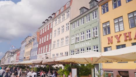 people near nyhavn waterfront buildings, entertainment district in copenhagen