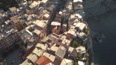 backwards droneshot over italian coastline village at sunrise 4k