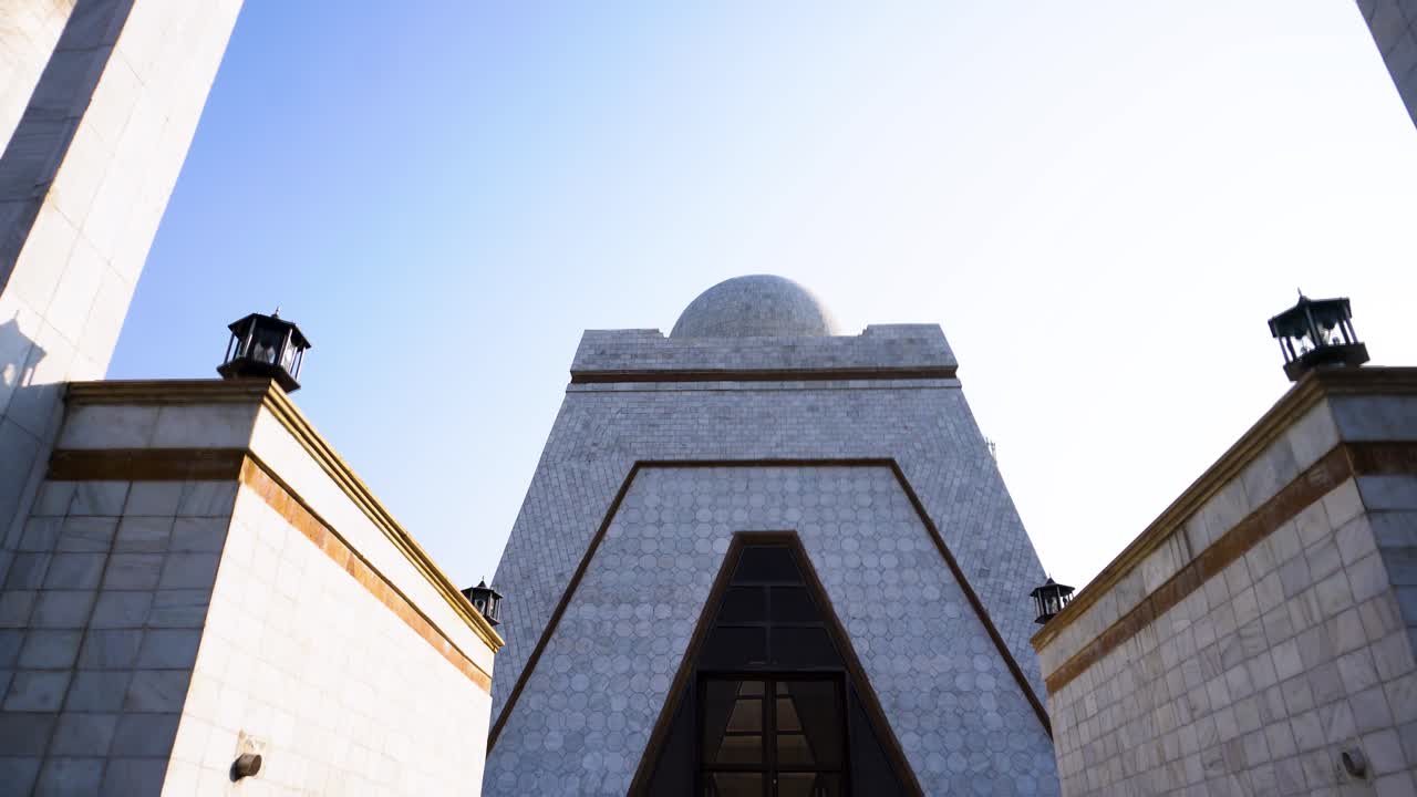 Downward motion showing white architectural structure with minaret.