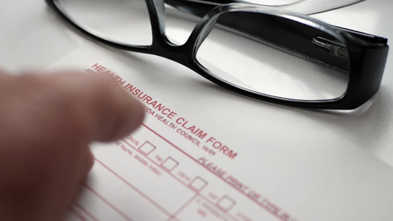 Finger tapping on health insurance claim form