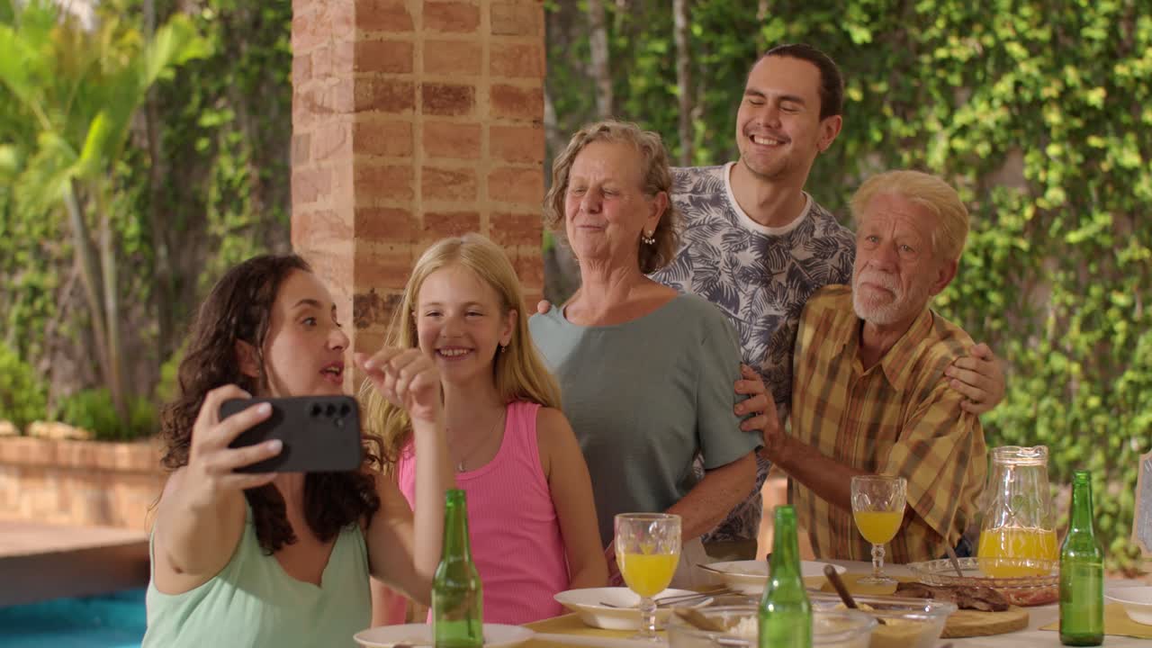 Happy family taking a selfie during an outdoor meal