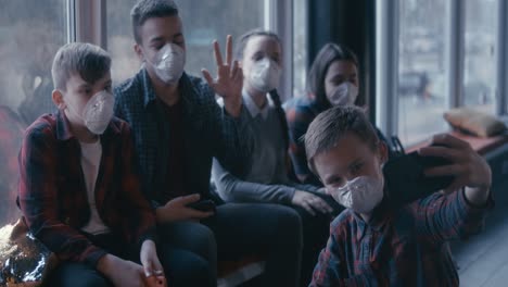 teenagers taking a selfie while wearing masks