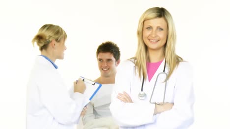 female doctors smiling at the camera and a male patient