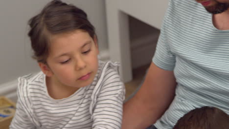 father reading story to children in their bedroom