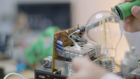 closeup shot of smart child soldering circuit board