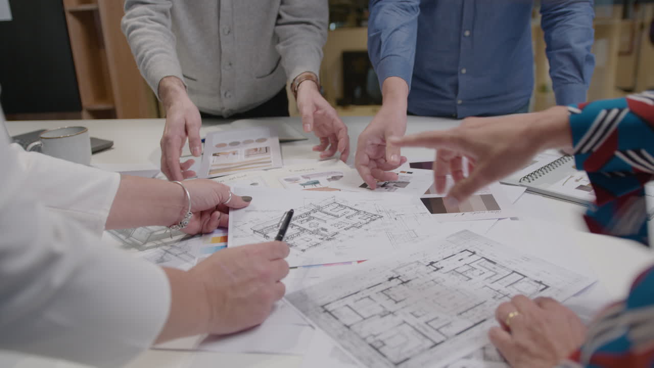 Business Team Working with Color Palettes and Architectural Plans