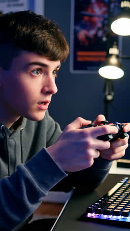 young man intensely playing video games with a controller