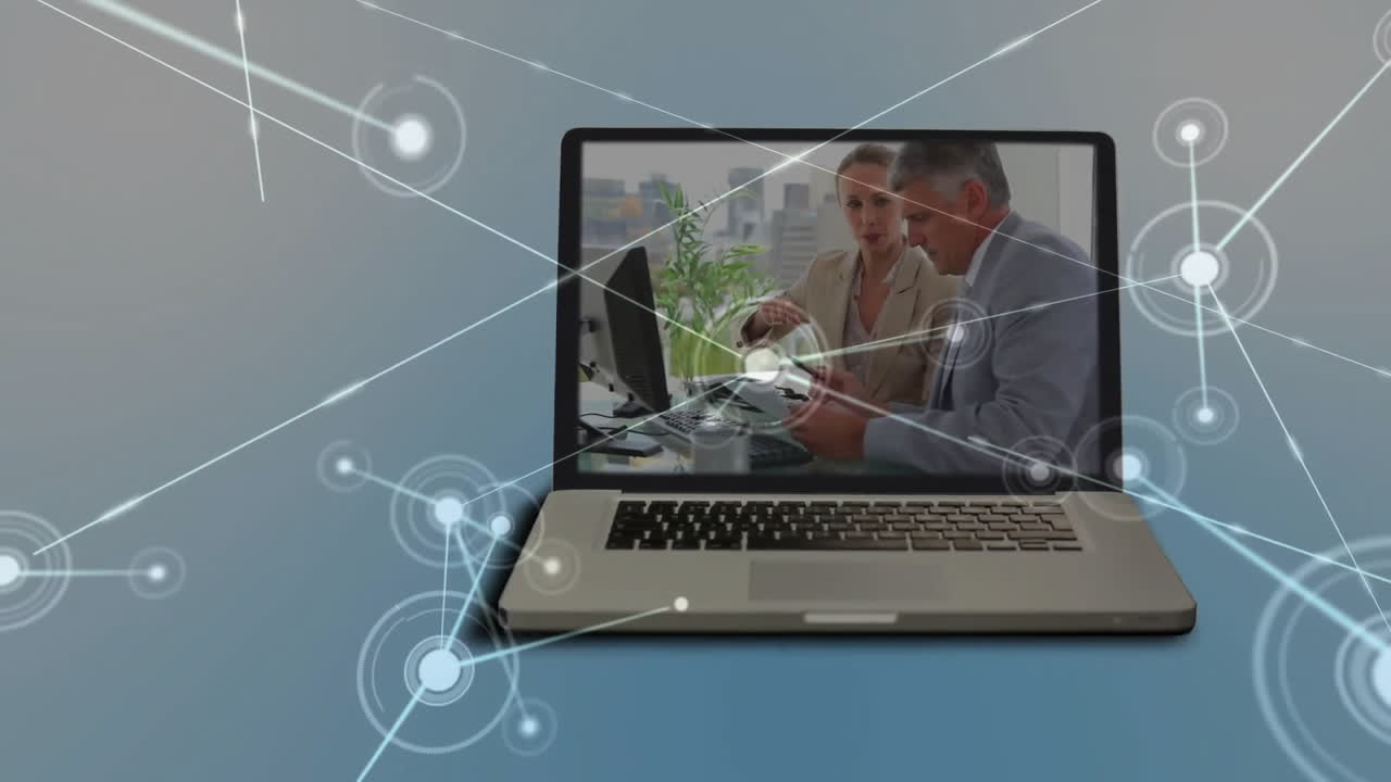 Animation of network of connections over caucasian colleagues working in office on laptop screen