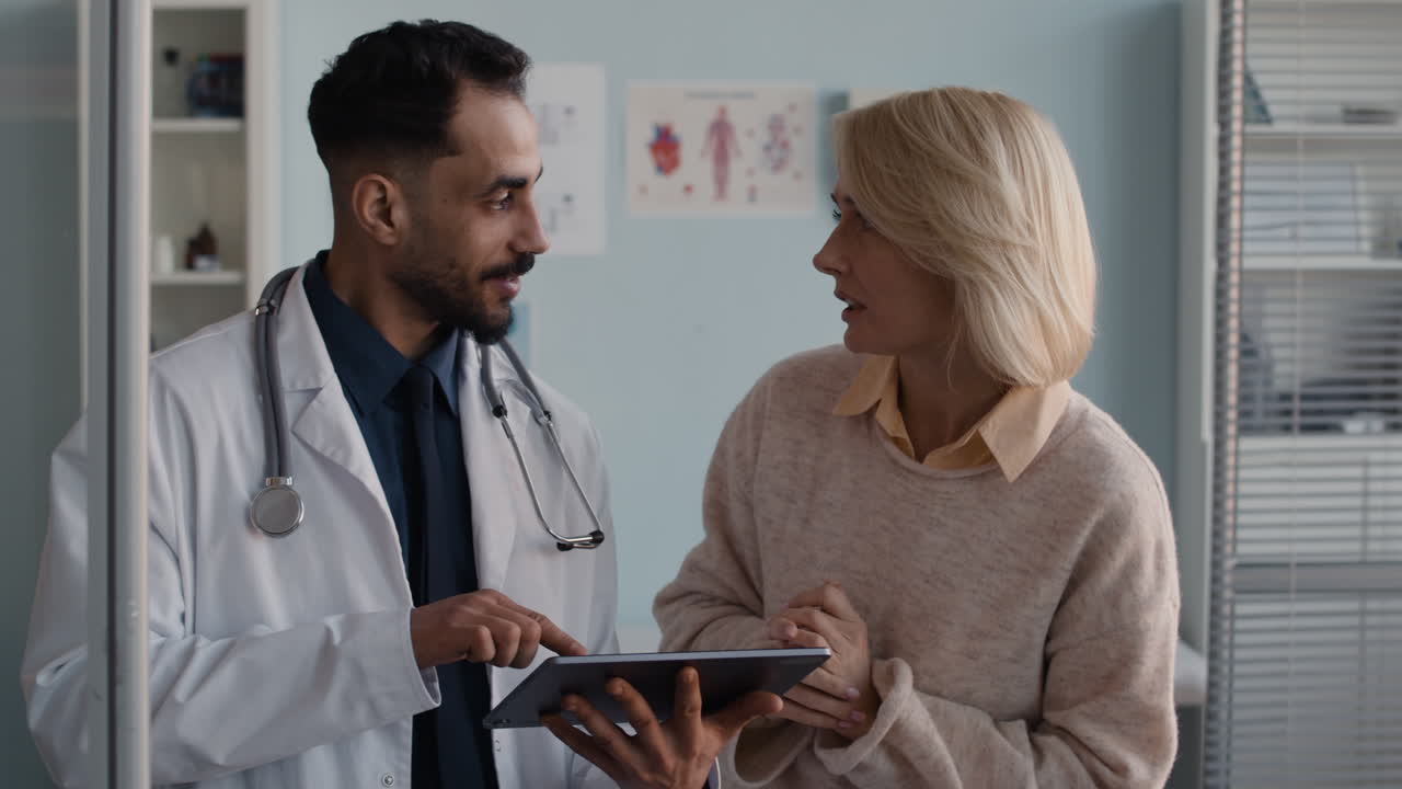 Doctor consulting patient with a tablet