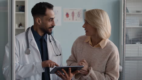 doctor consulting patient with a tablet