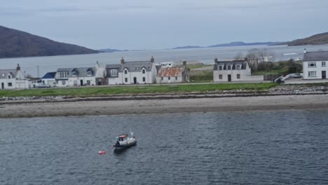 View-from-a-ferry-passing-by-the-waterfront-of-ullapool-in-Scotland