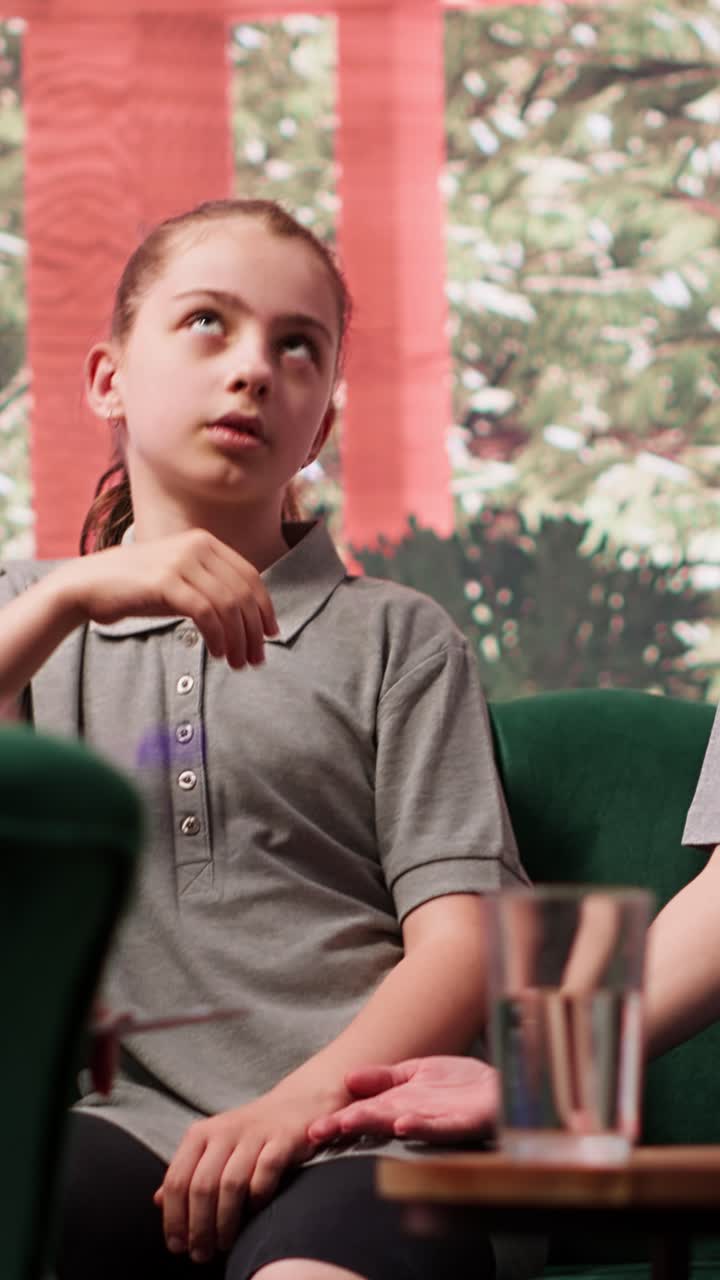 Young Girl Expressing Disinterest During Therapy Session with Mother