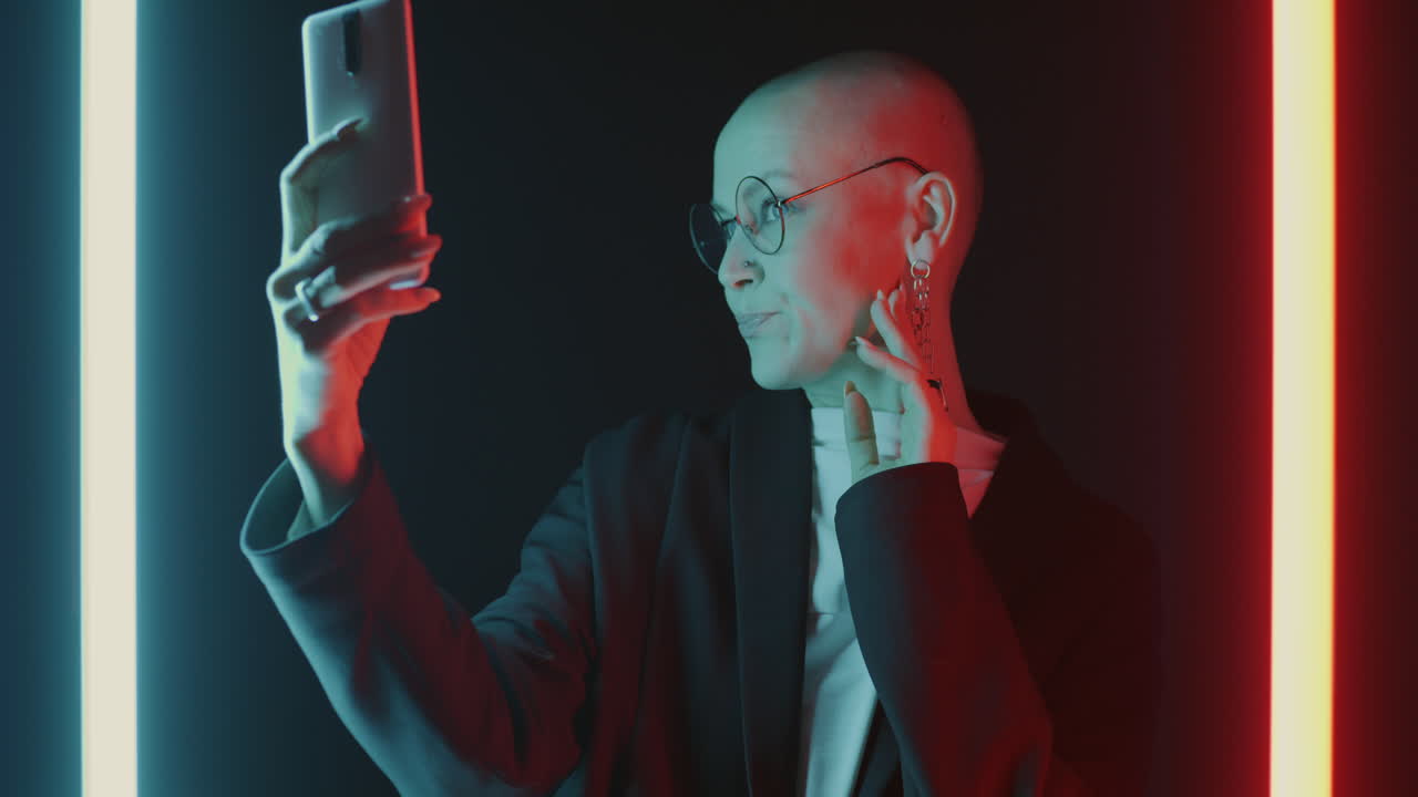 Confident Woman Taking a Selfie in Neon Lighting