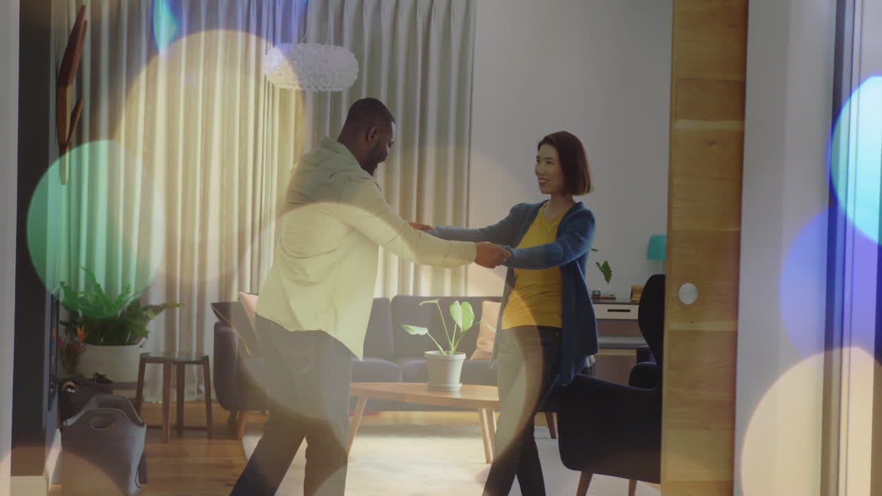 Dancing couple in living room with colorful bokeh lights animation