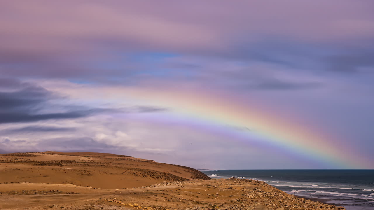 arco iris costero y lapso de tiempo de fusión cloudscape, colores cálidos brillantes