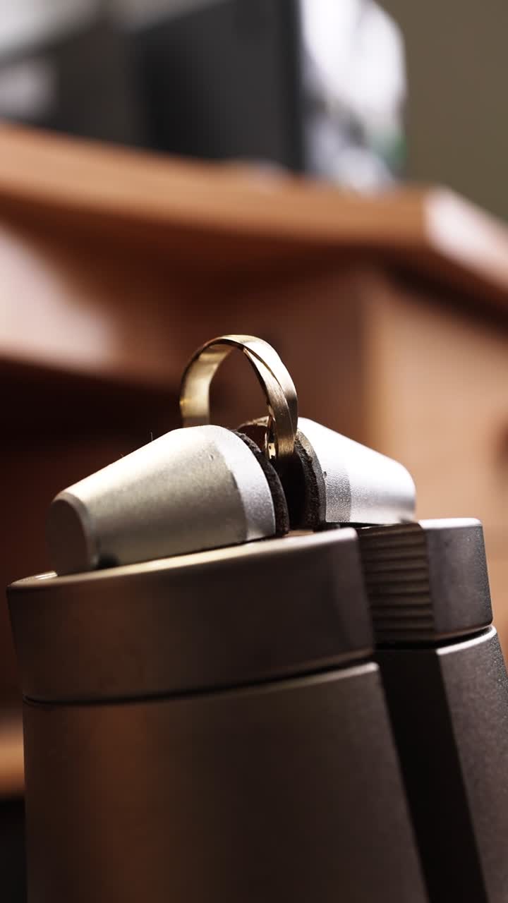 Close-up of a Gold Ring Held in a Jeweler's Clamp