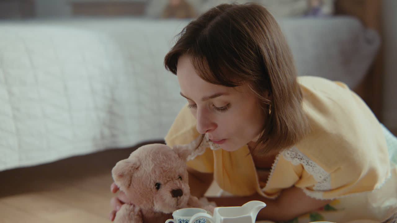 A girl playing with dolls in her room