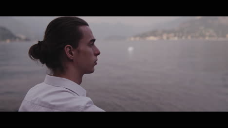 man smoking by the lake