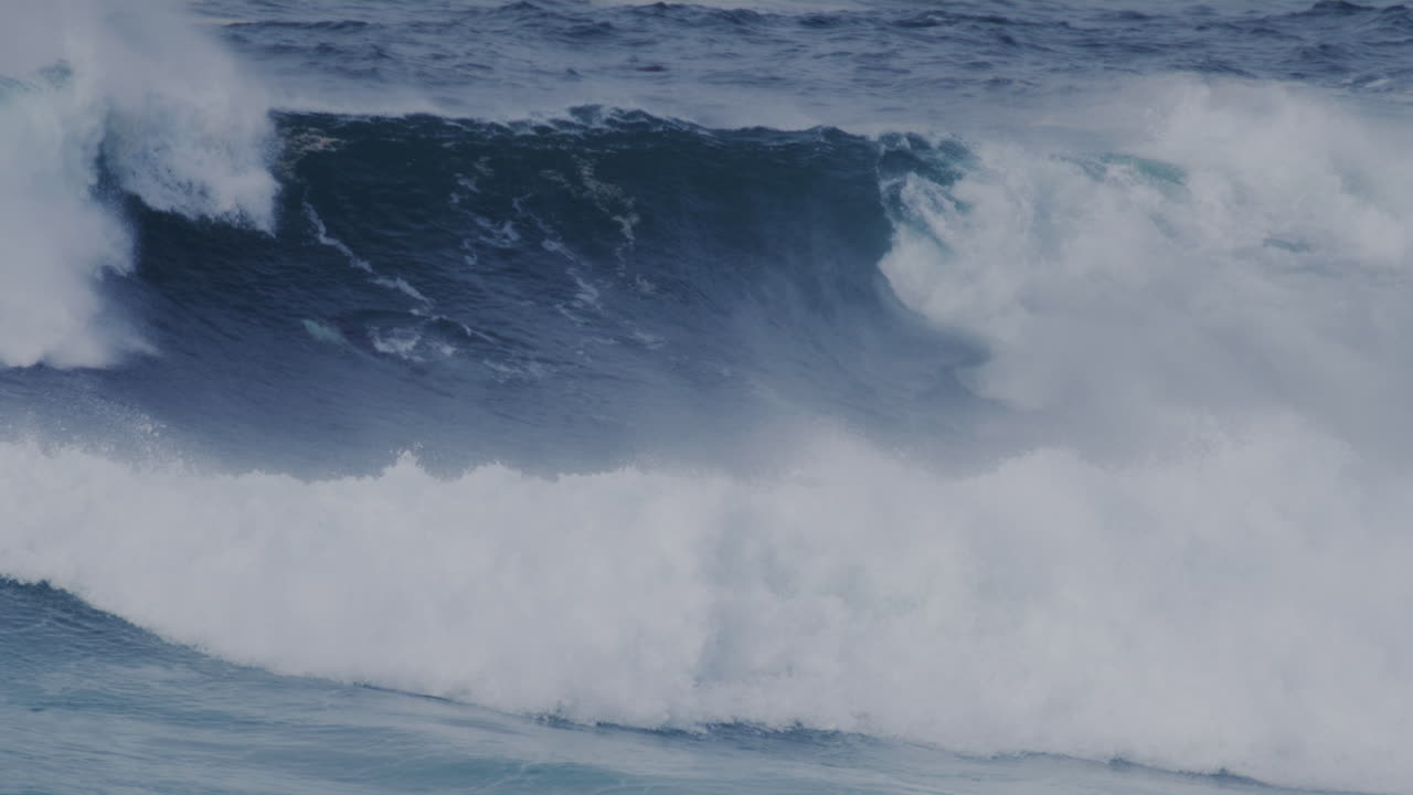 Large crashing waves in Sydney, Australia, with deep blue ocean and powerful water force.