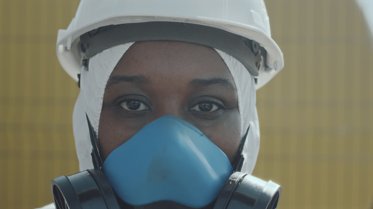 Portrait of Black Ecologist in Coverall and Respiratory Mask