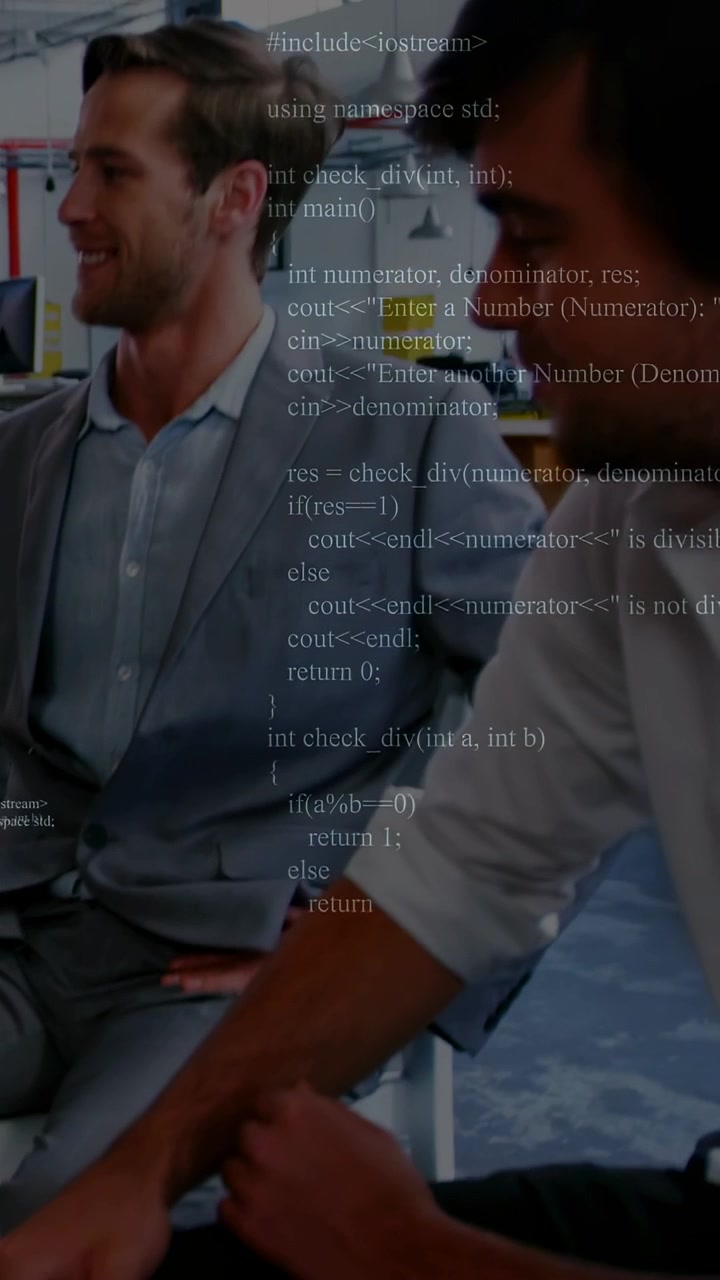 Vertical video: Man in suit tapping surface, activating C++ code overlay, colleague reviewing code