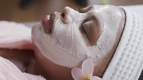 Close-up-of-african-american-plus-size-woman-with-beauty-face-mask,-unaltered,-slow-motion