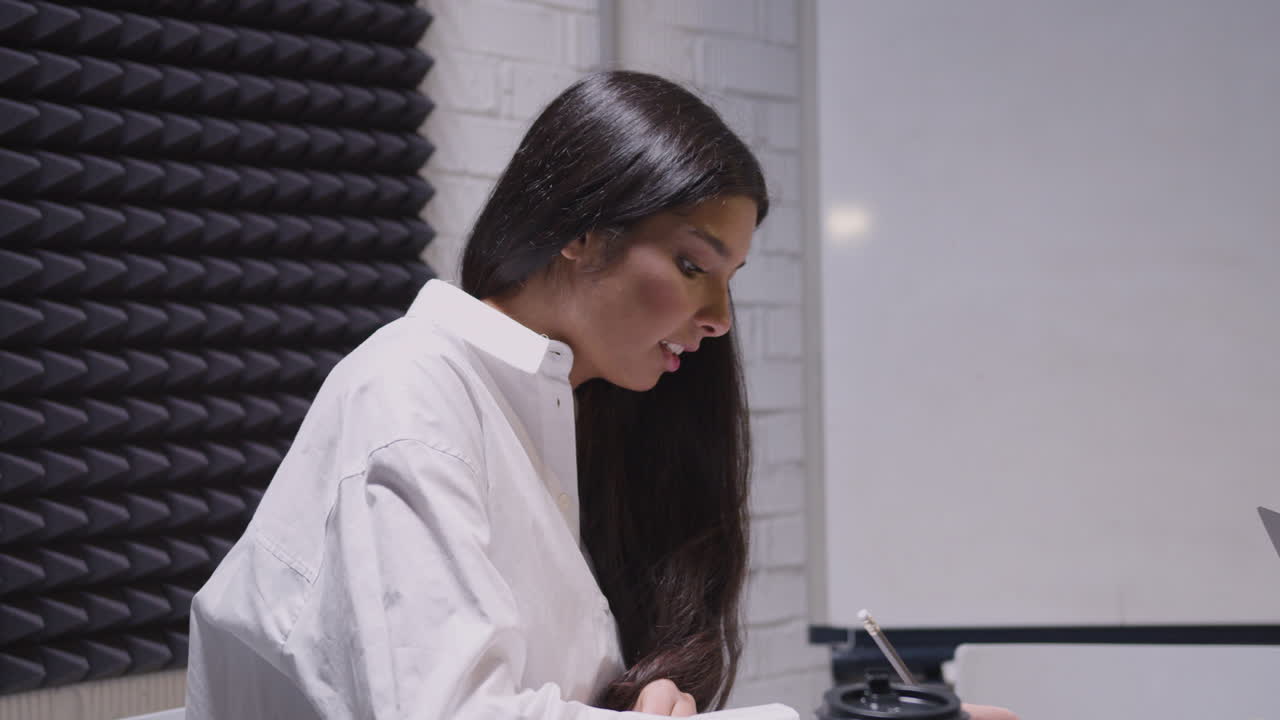 Businesswoman Writing On Paper With Pencil During A Business Meeting