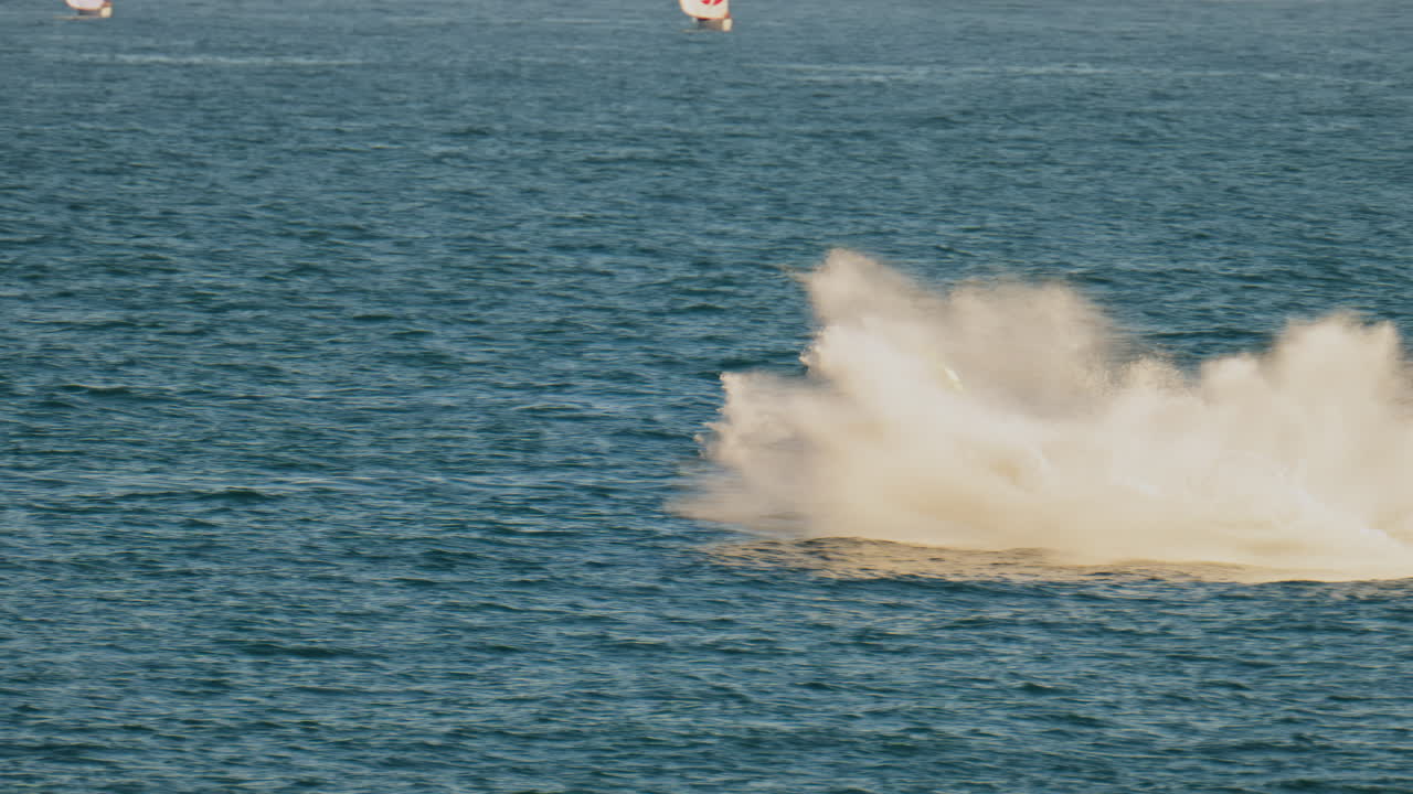 Nice, France - February 10, 2025: A boat with the flag of Monaco moving on the sea with small sailboats on the background