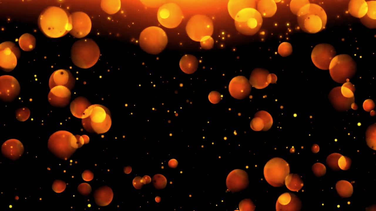 Glowing Orange and Gold Bokeh Particles Floating on Black Background