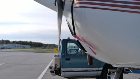 half truck tug behind cessna seaplane at the airfield