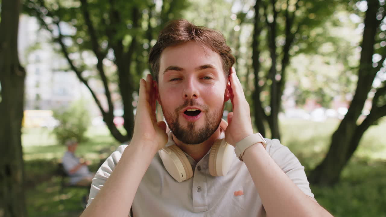 Man jogger looking surprised at camera with big open eyes shocked by sudden victory game winning