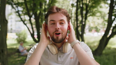 man jogger looking surprised at camera with big open eyes shocked by sudden victory game winning