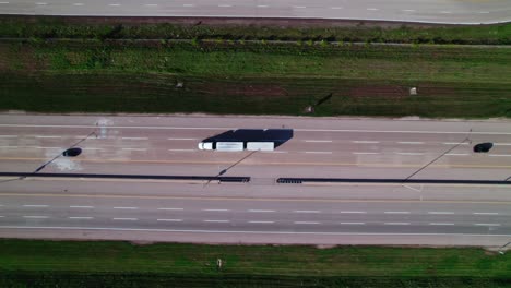 top down aerial of multi trailer truck driving on interstate 90