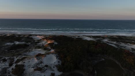 sunset scene with salt marsh and sand dunes in cape cod, barnstable massachusetts