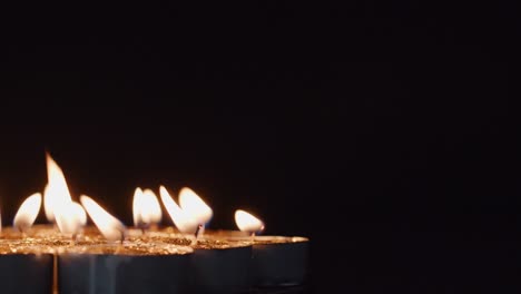 Background-of-tea-cup-glitter-Candles-Lights-shines-yellow-gold-bright-for-celebration,-religion,-anniversary-Festival