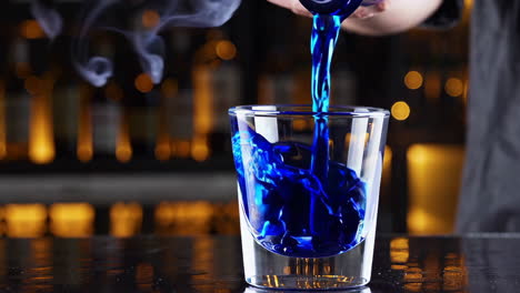 blue cocktail being prepared