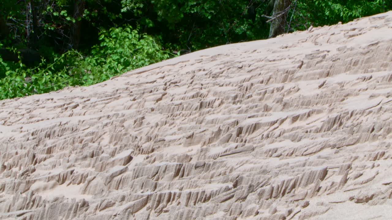 Detailed close up shot of jagged sand textures on dune slope, tilt down movement, Indiana Dunes, Lake Michigan