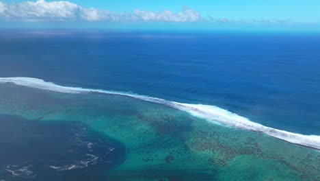 Teahupoo-Tahiti-aerial-drone-view-French-Polynesia-point-coast-channel-shallow-coral-reef-wave-surf-break-waves-crashing-aqua-blue-Pacific-Ocean-sea-sunny-Point-Faremahora-Pass-Havae-forward-pan-up