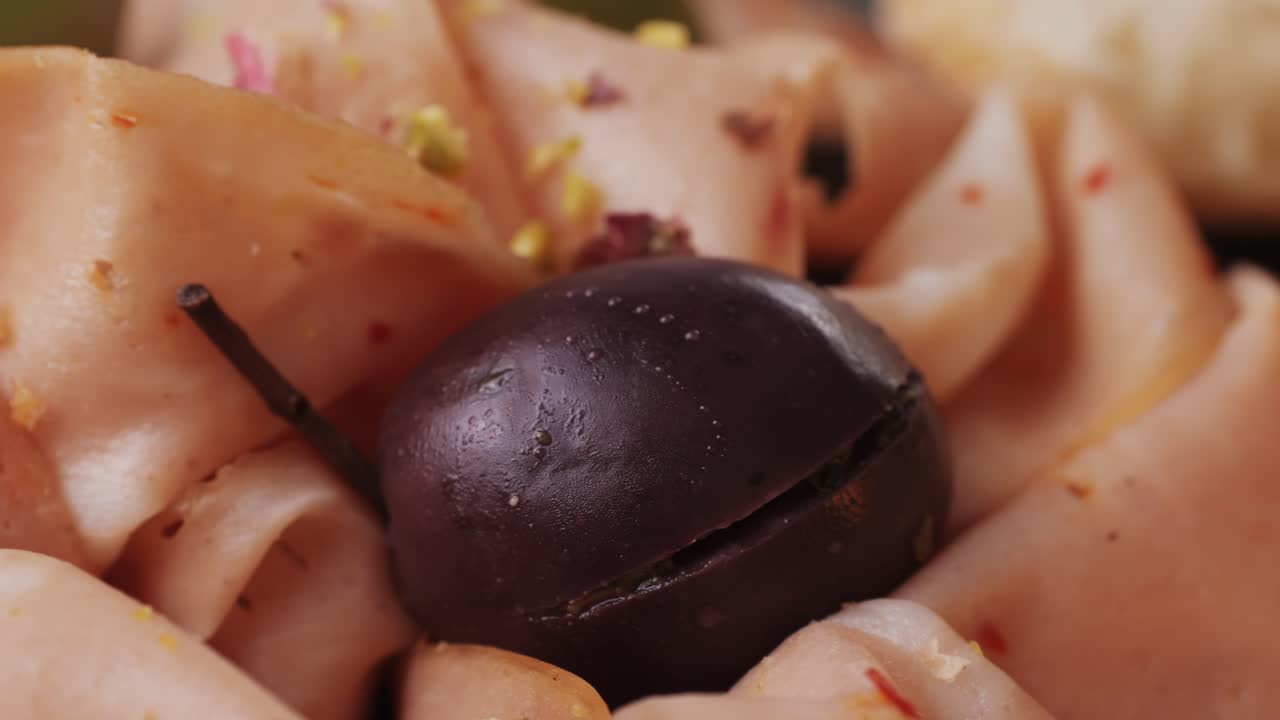 Ham italian mordatella, man Slices Of Traditional Italian antipasti mortadella sausage on a wooden cutting board, close up macro of chicken or turkey jamon, fat breakfast dish.