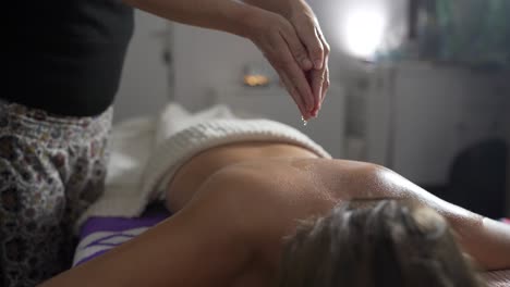Woman-massaging-back-of-client-in-salon