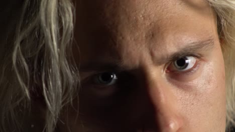 Close-up-of-a-blond-man-look-angry-at-the-camera-with-evil-eyes