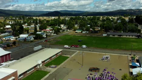 us, oregon, elgin, 2025-08-07 - drone view of a life flight helicopter landed in a grass field with two ambulances arriving