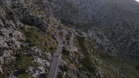 Aerial-shot-of-cars-passing-through-the-snake-road-Sa-Calobra-in-Mallorca,-Spain