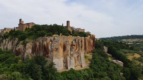 Establishing, aerial of medieval Orvieto town on a steep cliff in central Italy