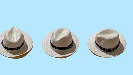 white straw wicker hat on a blue color background. seamless looping animation with hard shadows of the sun. minimal concept of travel and vacation